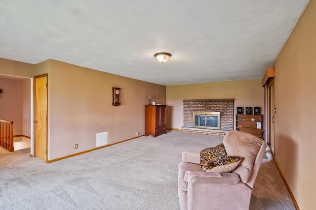 living room with a fireplace, baseboards, carpet, and visible vents