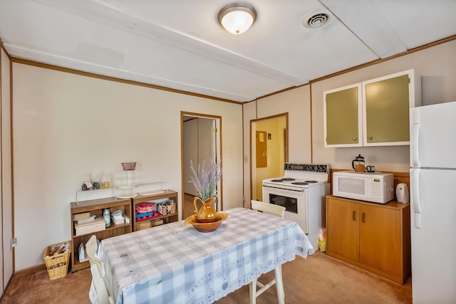 dining area with visible vents and light colored carpet