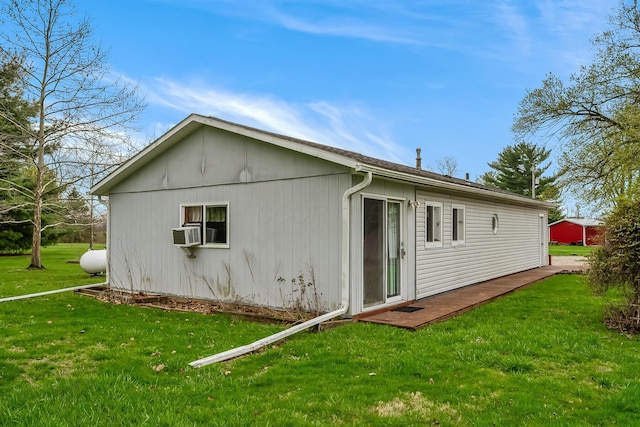 back of house featuring cooling unit and a lawn