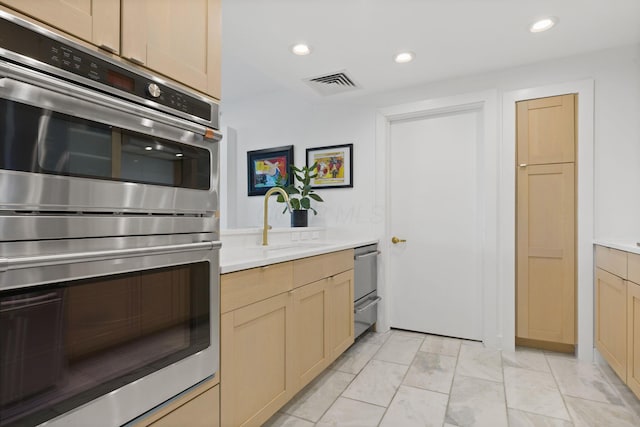 kitchen with visible vents, recessed lighting, light countertops, a sink, and stainless steel appliances