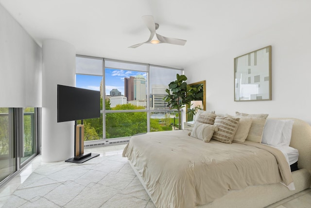 bedroom with floor to ceiling windows, multiple windows, and ceiling fan