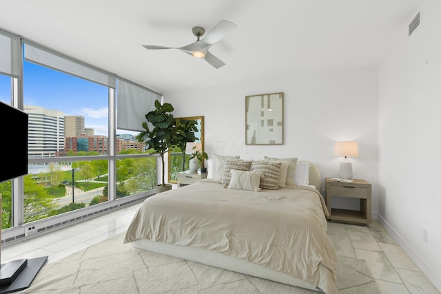 bedroom with ceiling fan, baseboards, visible vents, and expansive windows