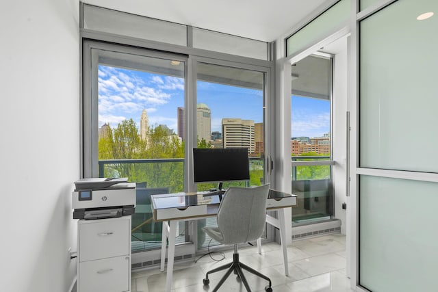 office area featuring plenty of natural light and marble finish floor