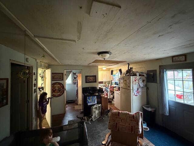 interior space featuring freestanding refrigerator and electric panel