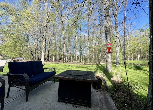 view of patio featuring an outdoor living space with a fire pit