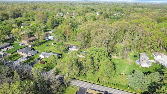 drone / aerial view featuring a residential view and a forest view