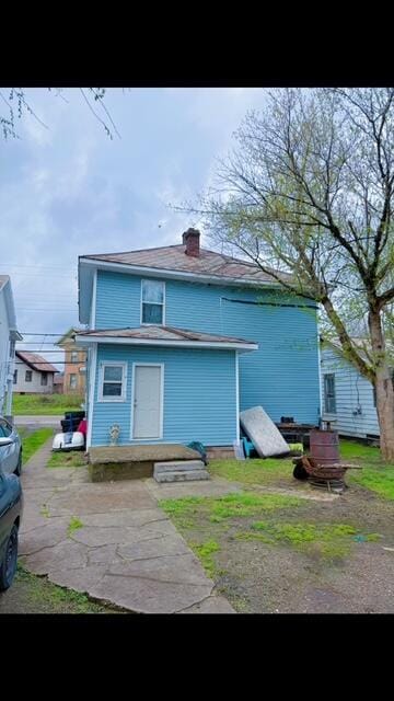 rear view of property with a chimney