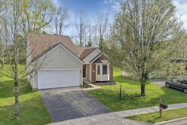 ranch-style home with driveway, a front lawn, brick siding, and an attached garage