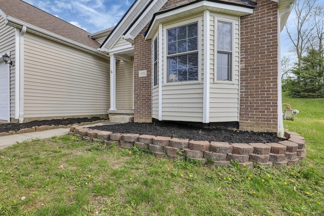 property entrance featuring brick siding