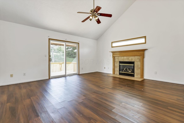 unfurnished living room featuring a tile fireplace, high vaulted ceiling, dark wood-type flooring, a ceiling fan, and baseboards