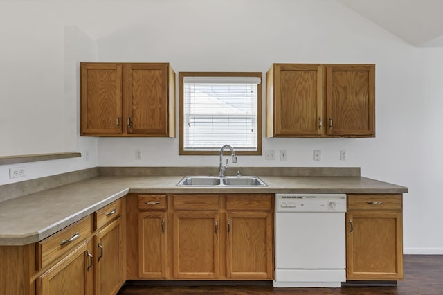 kitchen featuring brown cabinetry, white dishwasher, a sink, dark wood-style floors, and lofted ceiling