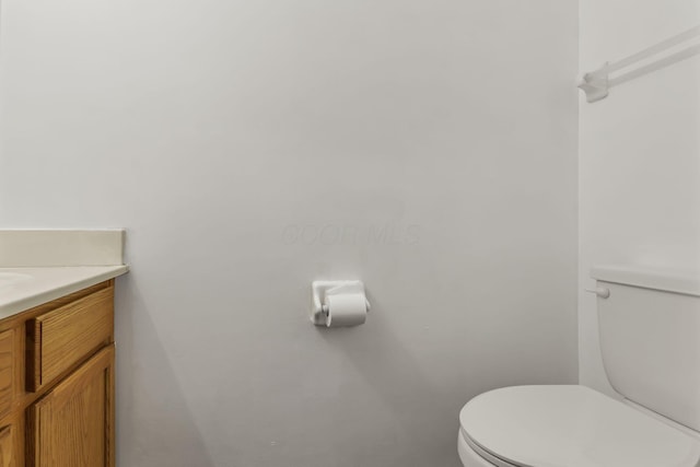 half bathroom with toilet and vanity