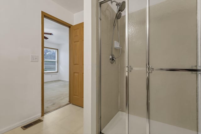 bathroom with baseboards, visible vents, tile patterned floors, and a shower stall