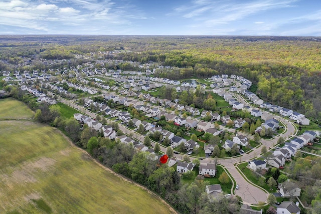 birds eye view of property featuring a residential view and a forest view