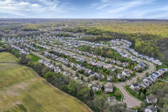 drone / aerial view with a residential view and a forest view