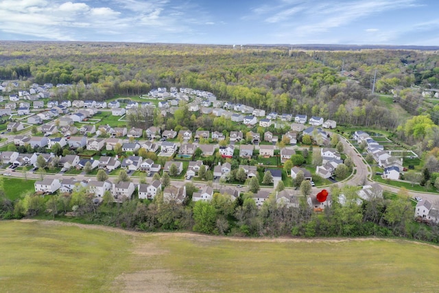 aerial view featuring a view of trees and a residential view