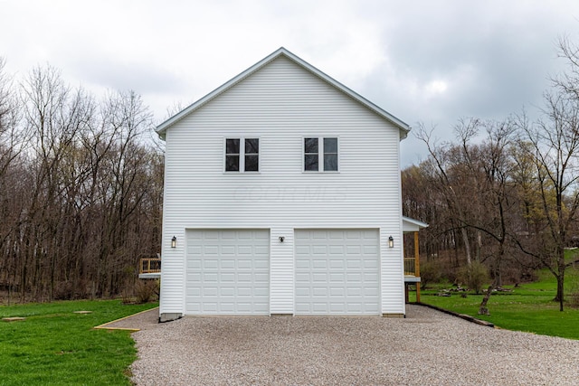 exterior space featuring a yard, an attached garage, and driveway