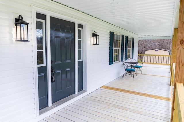 wooden terrace featuring covered porch