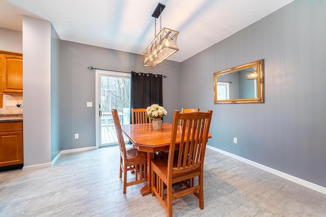 dining room with light wood-type flooring and baseboards