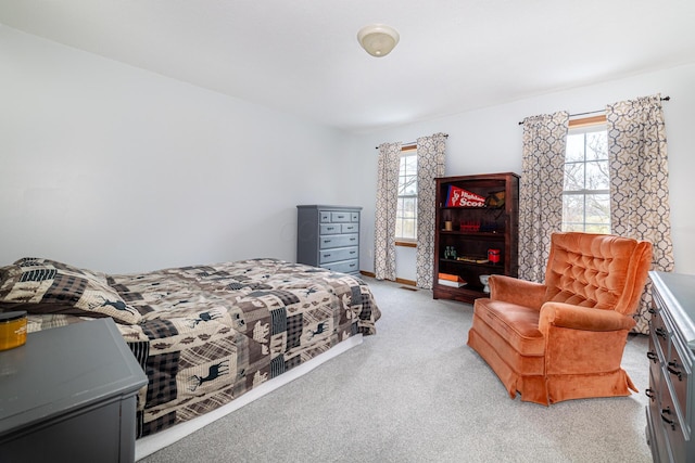 carpeted bedroom with baseboards and multiple windows