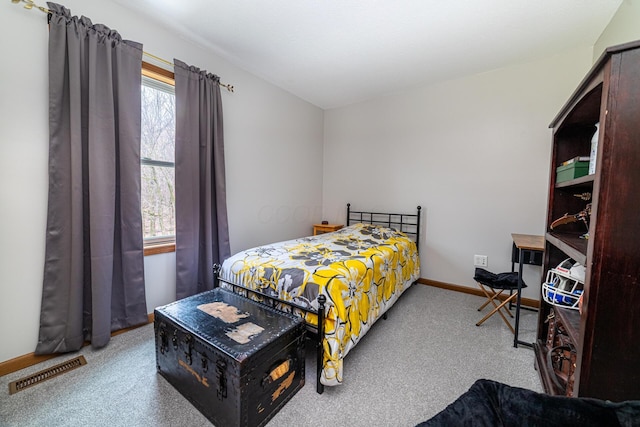 carpeted bedroom featuring baseboards and visible vents