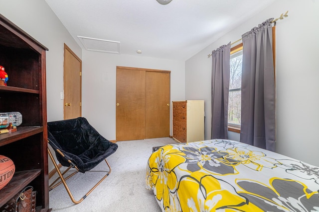 carpeted bedroom featuring a closet and attic access