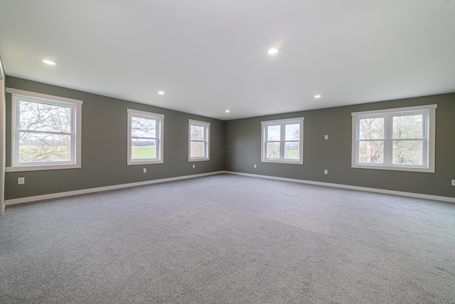 empty room featuring recessed lighting, carpet, and baseboards