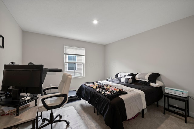 bedroom featuring carpet and baseboards