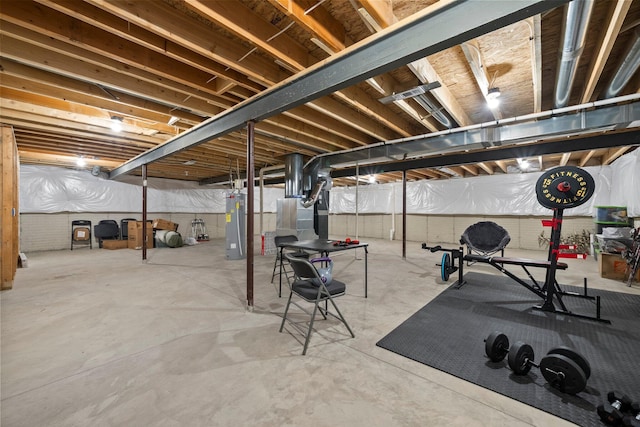 unfinished basement featuring electric water heater