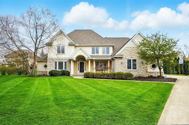 4201 Penrith Ct, Dublin, OH 43016 - craftsman inspired home with a front lawn, stone siding, a porch, stucco siding, and roof with shingles