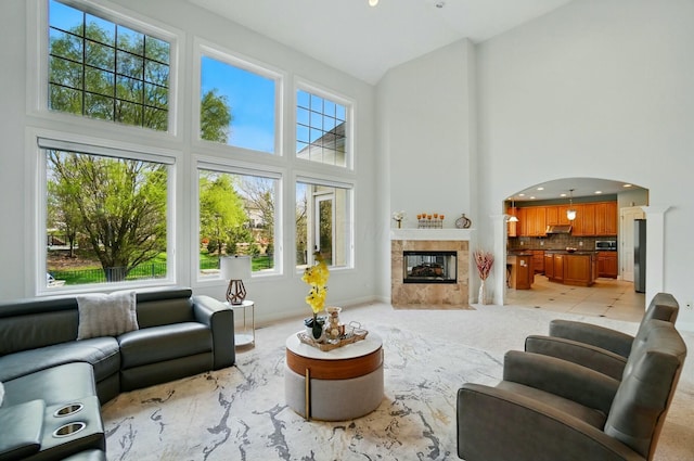4201 Penrith Ct, Dublin, OH 43016 - living room with arched walkways, a tile fireplace, and high vaulted ceiling