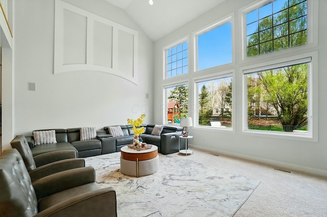 4201 Penrith Ct, Dublin, OH 43016 - carpeted living room with baseboards, visible vents, and high vaulted ceiling