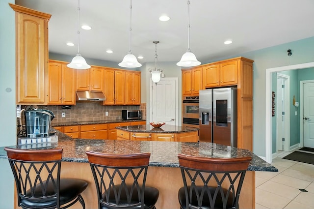 4201 Penrith Ct, Dublin, OH 43016 - kitchen featuring decorative backsplash, stainless steel appliances, under cabinet range hood, a kitchen island, and recessed lighting