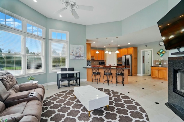 4201 Penrith Ct, Dublin, OH 43016 - living area featuring plenty of natural light, a towering ceiling, ceiling fan, and light tile patterned flooring