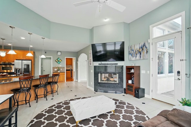 4201 Penrith Ct, Dublin, OH 43016 - living room with a towering ceiling, recessed lighting, a ceiling fan, a multi sided fireplace, and light tile patterned floors