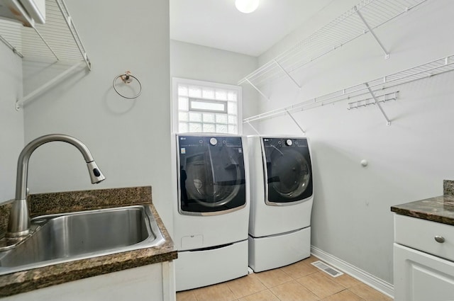 4201 Penrith Ct, Dublin, OH 43016 - clothes washing area with a sink, separate washer and dryer, light tile patterned floors, visible vents, and laundry area