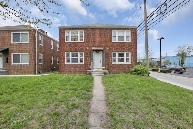 view of front facade featuring a front lawn and brick siding