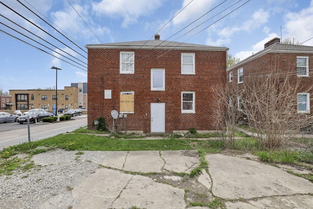 rear view of house featuring brick siding