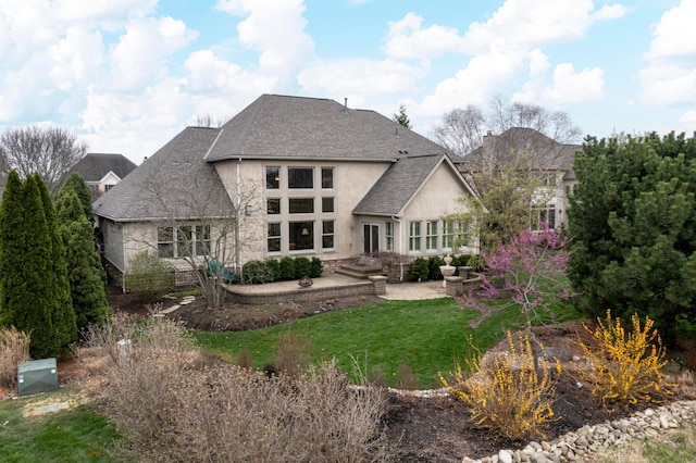 6700 Ballantrae Pl, Dublin, OH 43016 - back of property featuring a yard, stucco siding, a patio area, stone siding, and roof with shingles