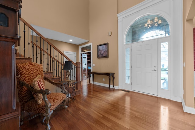 6700 Ballantrae Pl, Dublin, OH 43016 - foyer entrance with baseboards, a high ceiling, wood finished floors, and a healthy amount of sunlight