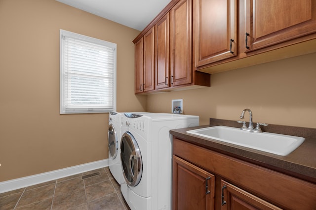 6700 Ballantrae Pl, Dublin, OH 43016 - laundry area with separate washer and dryer, visible vents, a sink, baseboards, and cabinet space