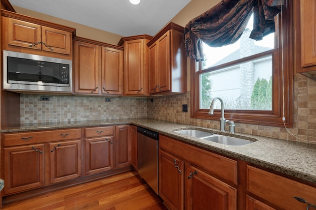 6700 Ballantrae Pl, Dublin, OH 43016 - kitchen with brown cabinets, dishwasher, a sink, and built in microwave