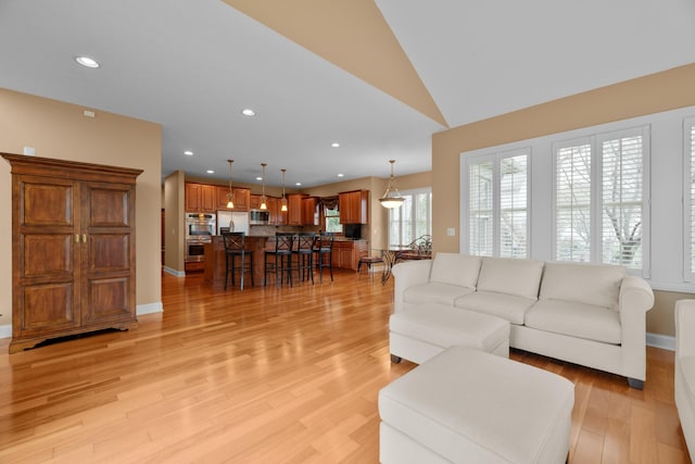 6700 Ballantrae Pl, Dublin, OH 43016 - living room featuring light wood-type flooring, recessed lighting, baseboards, and lofted ceiling