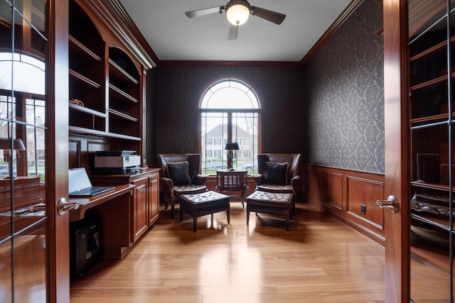 6700 Ballantrae Pl, Dublin, OH 43016 - sitting room featuring ornamental molding, a ceiling fan, light wood finished floors, wallpapered walls, and a wainscoted wall