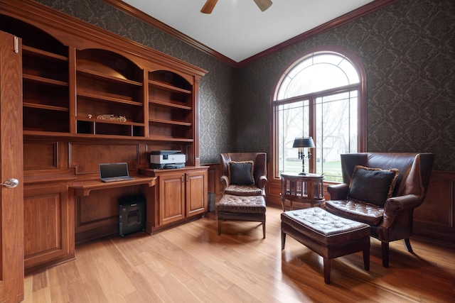 6700 Ballantrae Pl, Dublin, OH 43016 - sitting room with crown molding, ceiling fan, built in study area, wallpapered walls, and light wood finished floors