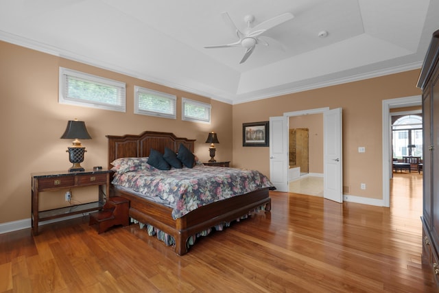 6700 Ballantrae Pl, Dublin, OH 43016 - bedroom with a tray ceiling, light wood-style floors, crown molding, and baseboards