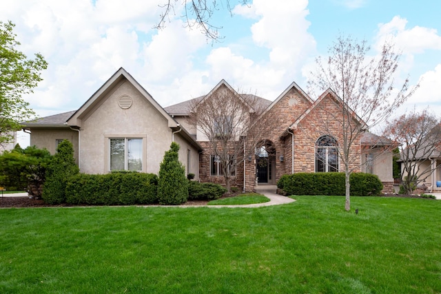 6700 Ballantrae Pl, Dublin, OH 43016 - view of front of home featuring a front yard, stone siding, and stucco siding