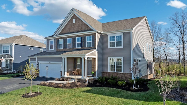 view of front of house featuring a porch, an attached garage, aphalt driveway, and a front lawn