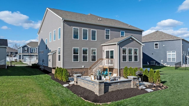 rear view of house with central AC, a patio, and a lawn