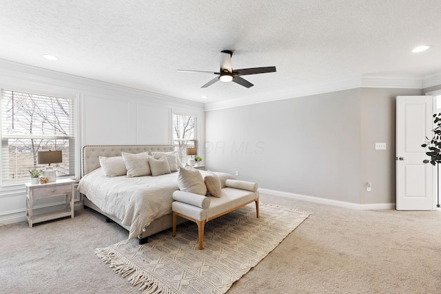 bedroom featuring crown molding, light colored carpet, and baseboards